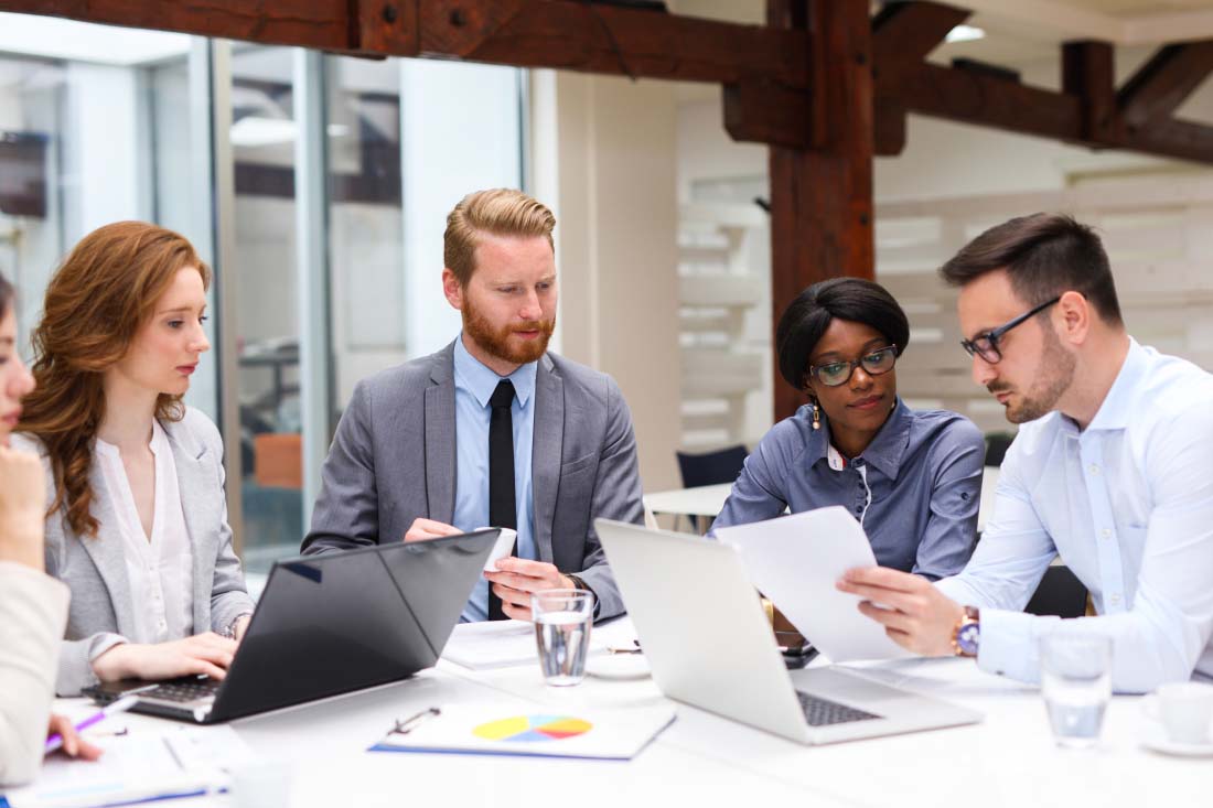 Team reviewing documents during an office meeting.