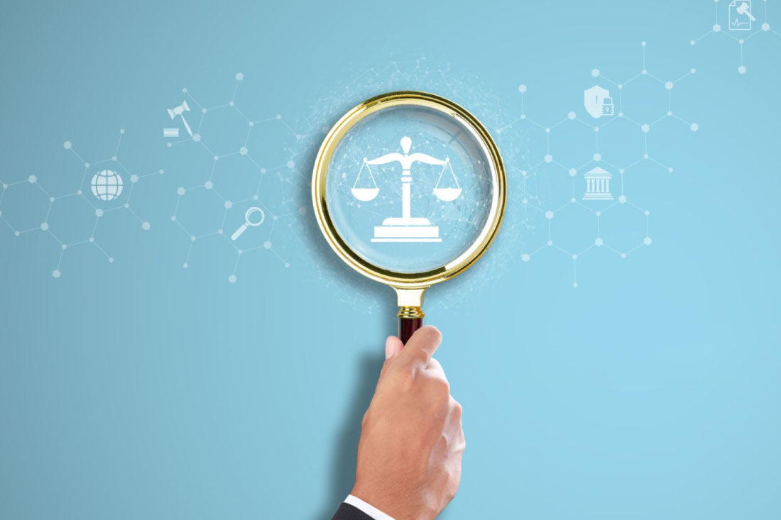 A magnifying glass highlighting the legal scales.