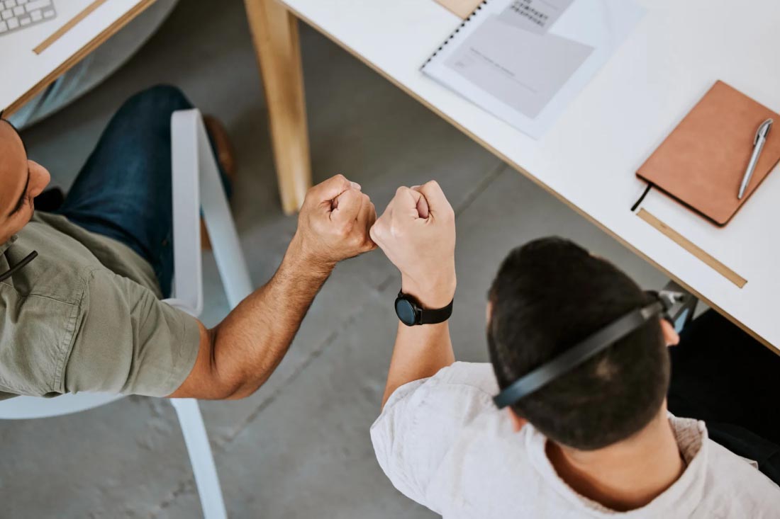 2 employees excited about their hybrid work advantages