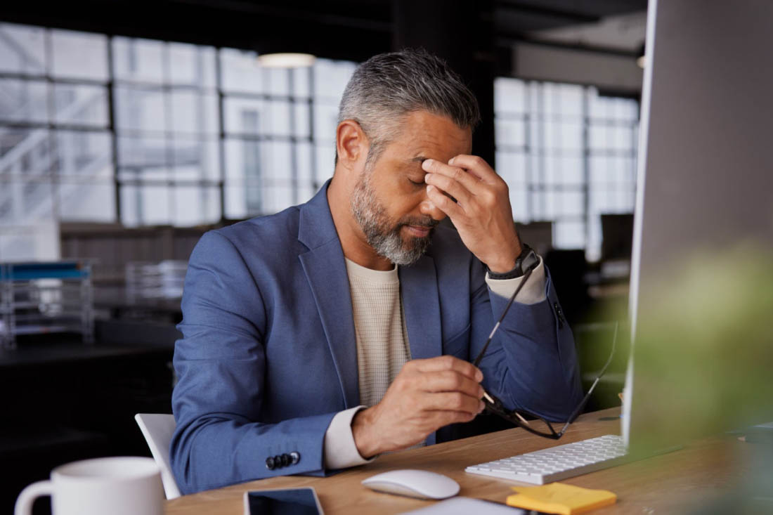 An employee experiencing the challenges of a hybrid work environment.