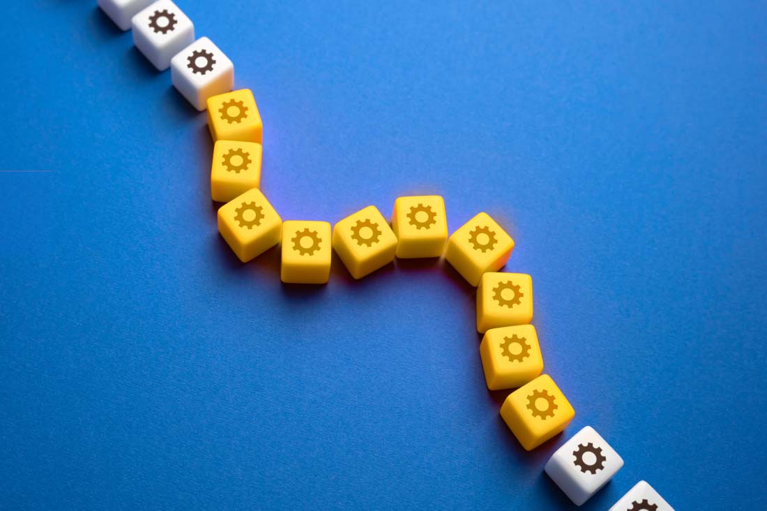 A series of gears in a curved line to suggest the need for streamlined insurance operations.