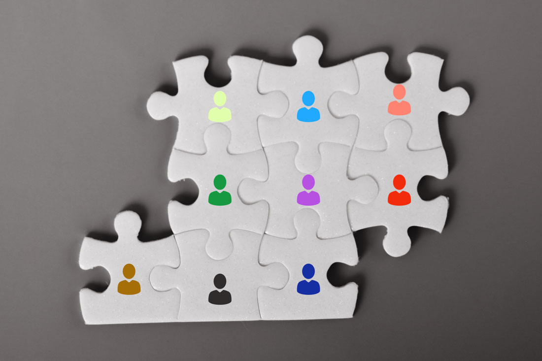 Puzzle pieces with employee icons to symbolize capacity management.